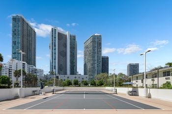 Outdoor tennis court with city skyline views